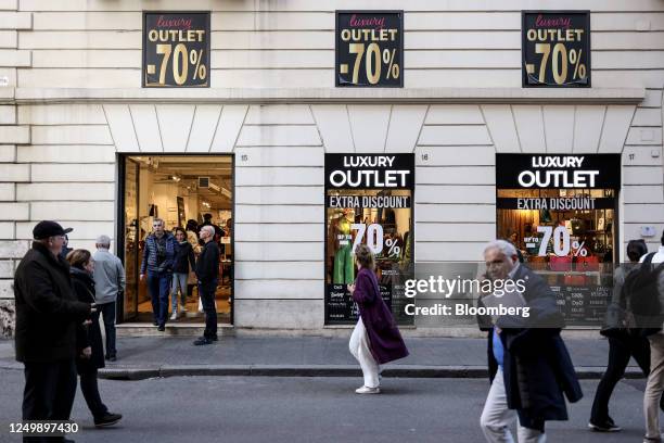 Pedestrians pass a discounted luxury outlet clothing store in downtown Rome, Italy, on Tuesday March 28, 2023. Italy is due to report their latest...