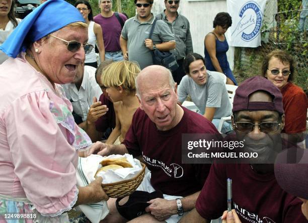 Bobby Charlton , 1966 world soccer champion for England and Edwin Moses both members of the Laureus World Sports Academy, speak with underprivileged...