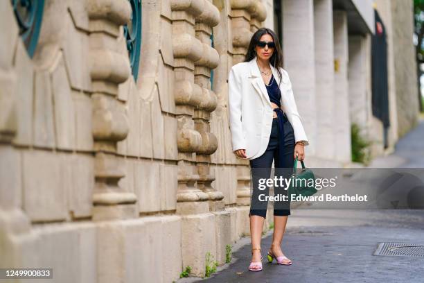 Street style photo session with Gabriella Berdugo wearing Prada sunglasses, Shaker Jewel jewelry, a white oversized blazer jacket from Salisa, a...