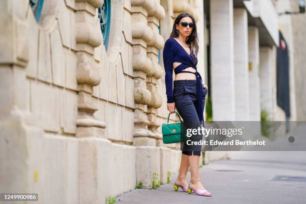 Street style photo session with Gabriella Berdugo wearing Prada sunglasses, Shaker Jewel jewelry, a green Chanel quilted bag, a navy blue cropped top...