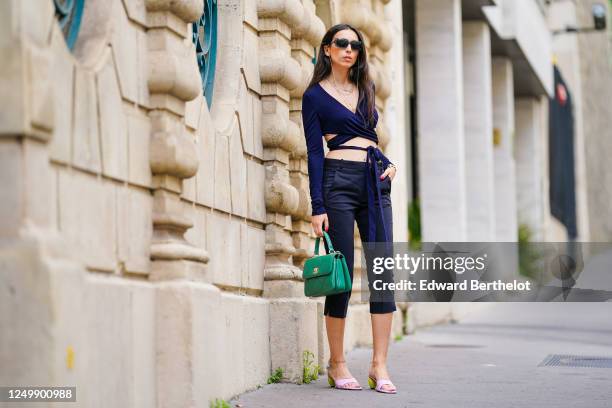 Street style photo session with Gabriella Berdugo wearing Prada sunglasses, Shaker Jewel jewelry, a green Chanel quilted bag, a navy blue cropped top...