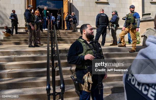 Police maintain a presence outside a command center holding evacuated students following the lockdown of the school after a call of an active shooter...