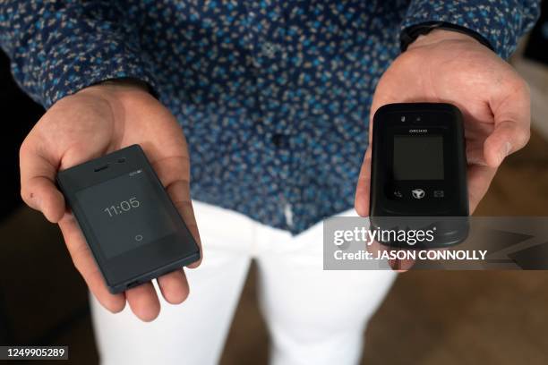 Jose Briones displays his Light Phone 2 and Sunbeam F1 phone at his apartment in Littleton, Colorado, on March 24, 2023. - Briones decided to stop...