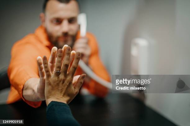 wife in visit to husband in prison - prison jumpsuit stock pictures, royalty-free photos & images