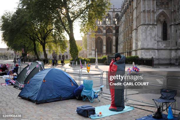 Royal fan wraps up in his sleeping bag as he camps outside Westminster Abbey on April 27 awaiting the royal wedding between Britain's Prince William...