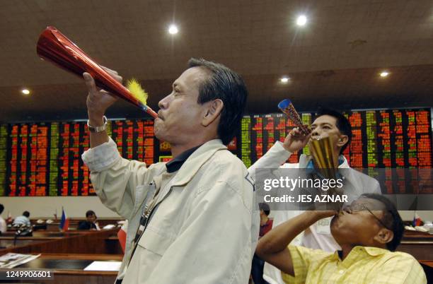 Traders blow new year horns on the trading floor as the Philippine Stocks Exchange in Makati business district closes its on the last day of trading,...