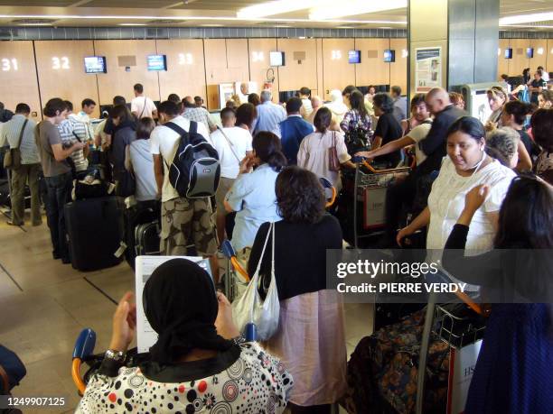 Passengers queue up at Orly Paris airport on August 1, 2008 on the first day of a crowded travel week-end as July and August tourists cross. AFP...