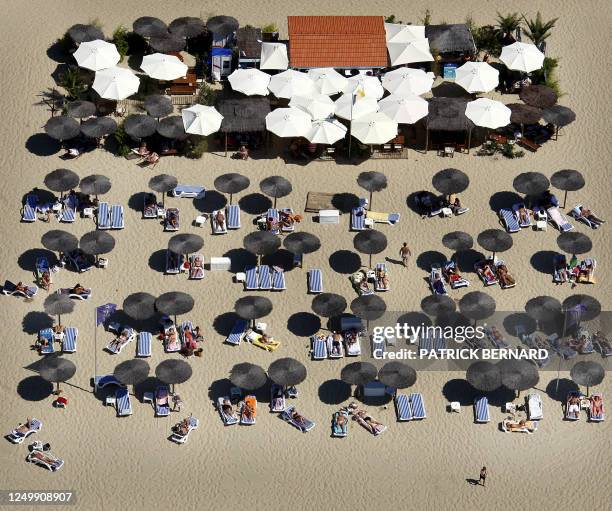 This aerial photography taken on July 19, 2008 shows people enjoying the beach along the basin of Arcachon, on the French atlantic coast,...