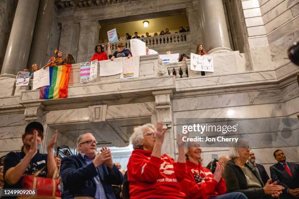 Supporters of SB 150 clap during a press conference in support of SB 150 while those opposed to the bill show signs above on March 29, 2023 at the...