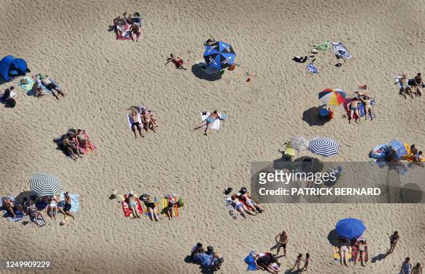 This aerial photography taken on July 19, 2008 shows people enjoying the beach along the basin of Arcachon, on the French atlantic coast,...