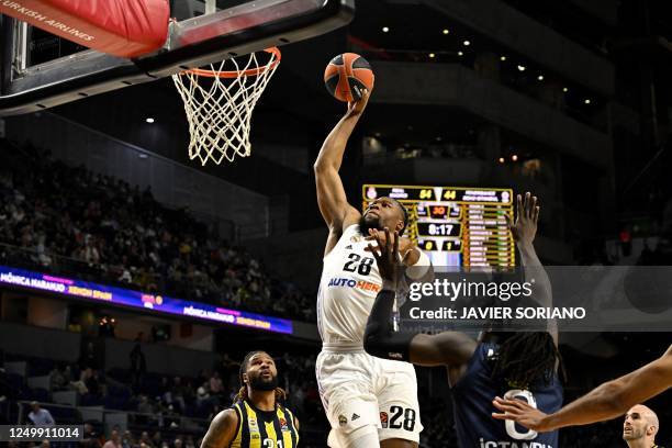 Real Madrid's French forward Guerschon Yabusele vies with Fenerbahce's US centre Johnathan Motley during the Euroleague basketball match between Real...