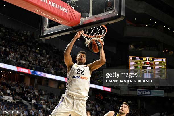 Real Madrid's Cape Verdean centre Walter Tavares scores during the Euroleague basketball match between Real Madrid Baloncesto and Fenerbahce at the...