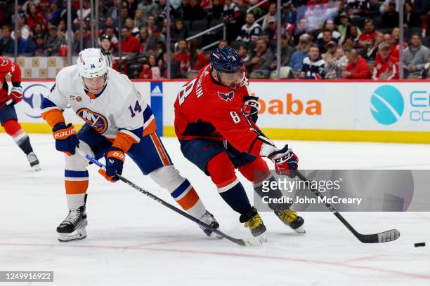 Alex Ovechkin of the Washington Capitals takes a shot on net as he is defended by Bo Horvat of the New York Islanders during a game at Capital One...