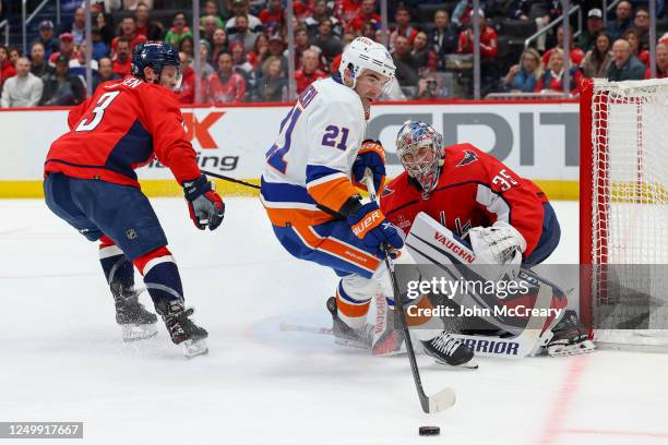 Darcy Kuemper of the Washington Capitals makes a save on Kyle Palmieri of the New York Islanders in the second period of a game at Capital One Arena...