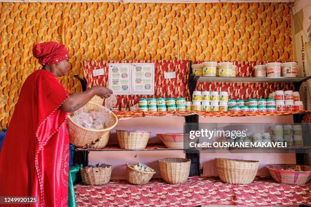 Woman sorts her products in a Karite butter shop in Siby on March 21, 2023. - Shea, a tree indigenous to Africa, and whose fruit is collected almost...