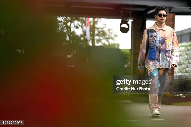 Zhou Guanyu of China arrives in the paddock ahead of the 2023 Formula 1 Australian Grand Prix at Albert Park in Melbourne on the 30th of March, 2023.