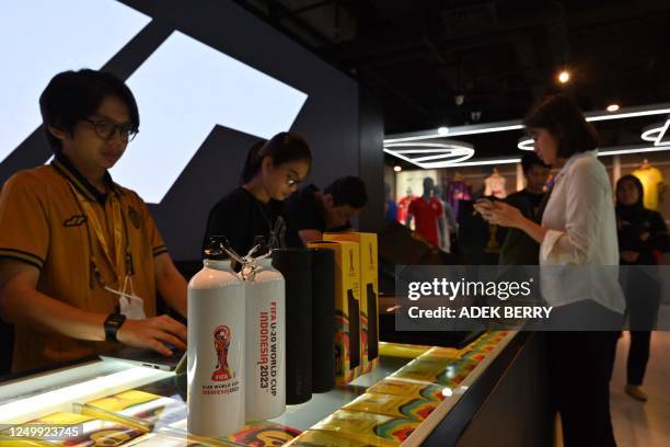 This picture shows official merchandise for the Indonesia 2023 FIFA Under-20 World Cup football tournament at a shop in Jakarta on March 30, 2023. -...