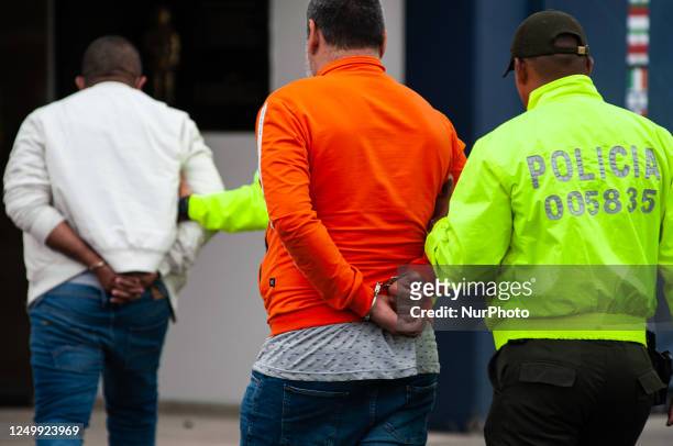 Colombian judicial police and Interpol officers transport the alleged 52 captures are seen outside of the Interpol police headquarters during a press...