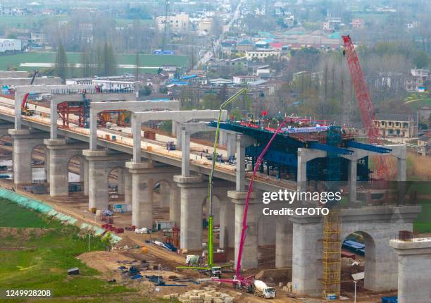 Workers of the Second Aviation Bureau of China Communications carry out concrete pouring for the first road beam in Chaohu-Ma'anshan Intercity...