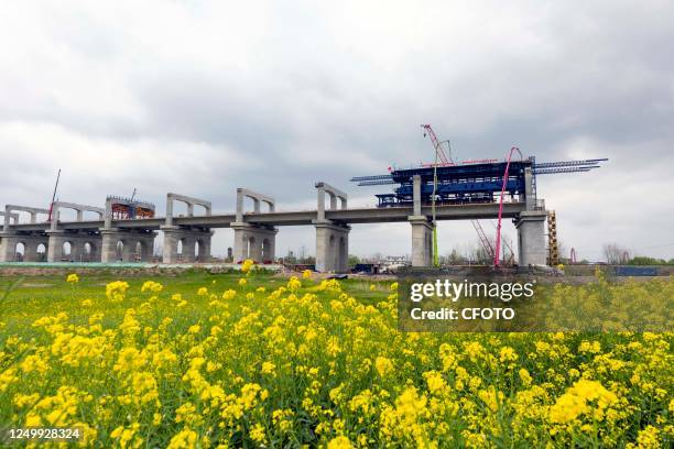 Workers of the Second Aviation Bureau of China Communications carry out concrete pouring for the first road beam in Chaohu-Ma'anshan Intercity...