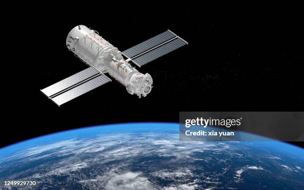 core module of china's space station tianhe orbiting earth - china rocket launch stock pictures, royalty-free photos & images