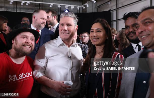 Britain's main opposition Labour Party leader Keir Starmer reacts during the launch of Labour's Local Election campaign in Swindon, west of London,...