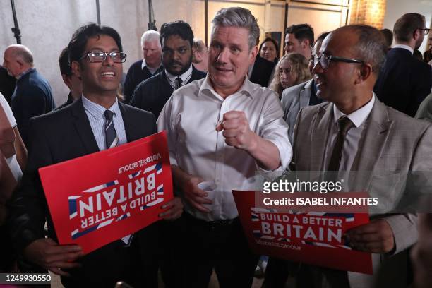 Britain's main opposition Labour Party leader Keir Starmer reacts during the launch of Labour's Local Election campaign in Swindon, west of London,...