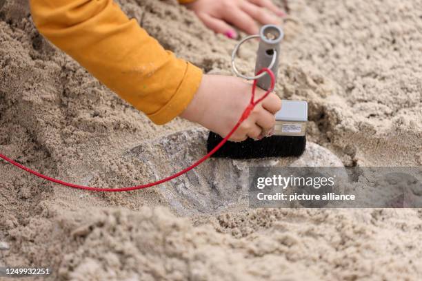 March 2023, Berlin: A child digs up "fossils" in a sandbox at the opening of Dinoworld Berlin at Tierpark Berlin. Until October, visitors to Tierpark...