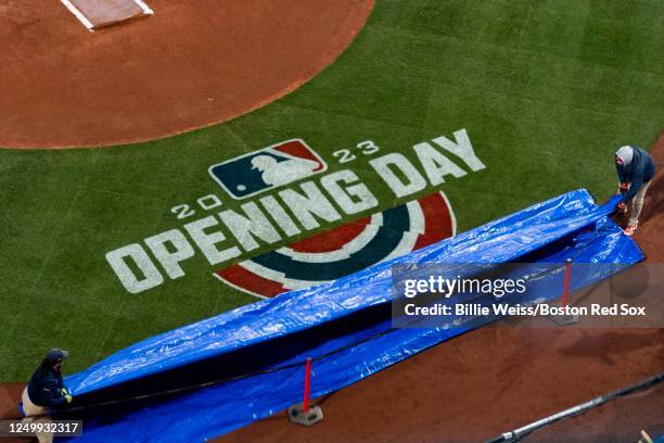 The tarp is removed to reveal the Opening Day logo before the 2023 Opening Day Game game between the Boston Red Sox and the Baltimore Orioles on...