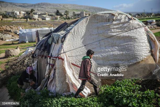 Child walks near a damaged tent as windstorm becomes effective for 2 days and hit 32 thousand civilians in 60 refugee camps for displaced people and...