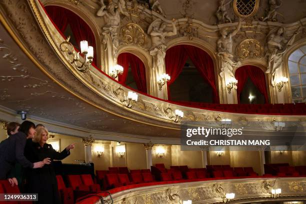 Britain's Camilla, Queen Consort , and the German President's wife Elke Buedenbender are guided by the Managing Director of the Komische Oper Susanne...