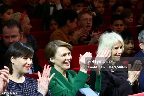 Britain's Camilla, Queen Consort , applauds next to German President's wife Elke Buedenbender and Managing Director of the Komische Oper Susanne...