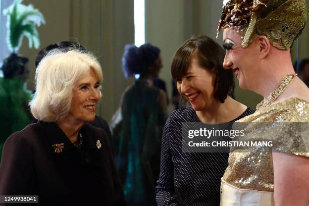 Britain's Camilla, Queen Consort , speaks with a Komische Oper Berlin performer next to Managing Director of the Komische Oper Susanne Moser during a...