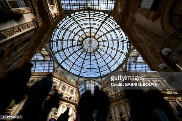 People visit the Galleria Vittorio Emanuele II shopping gallery on March 29, 2023 in central Milan. - Italy's oldest active shopping gallery and a...