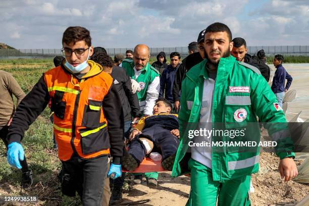 An injured Palestinian protestor is carried away by paramedics following clashes with Israeli security forces along the Gaza-Israel border east of...