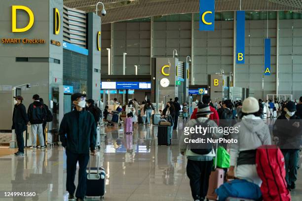 Passengers with luggages at Incheon International Airport on March 30 South Korea. According to Incheon International Airport Corporation, the...
