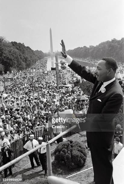 Civil rights leader Martin Luther King waves to supporters on August 28, 1963 on the Mall in Washington DC during the "March on Washington", where...