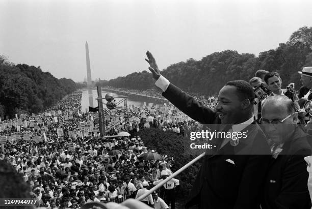 Civil rights leader Martin Luther King waves to supporters on August 28, 1963 on the Mall in Washington DC during the "March on Washington", where...