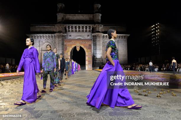 Models present creations from Christian Dior's Fall 2023 collection during a fashion show in Mumbai on March 30, 2023.