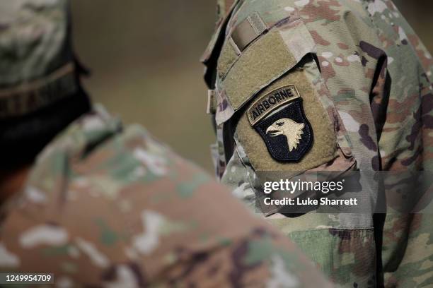 Soldiers from the U.S. Armys 101st Airborne Division stand guard at a checkpoint near the site where two UH-60 Blackhawk helicopters crashed on March...