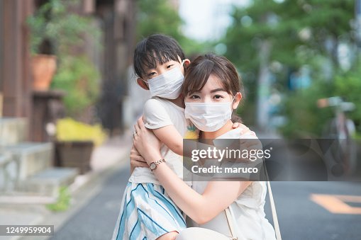 Asian mom and daughter wearing masks Asian mom and daughter wearing masks