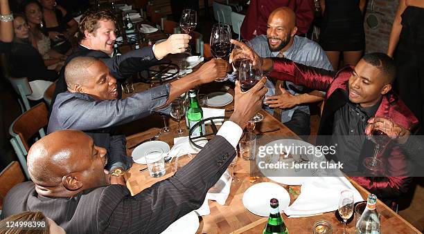 Jay-Z, Common and Nas toast during Nas' 38th birthday party at Catch on September 14, 2011 in New York City.