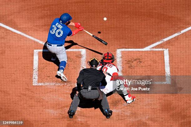 Alejandro Kirk of the Toronto Blue Jays hits a two-run single against the St. Louis Cardinals in the first inning on Opening Day at Busch Stadium on...