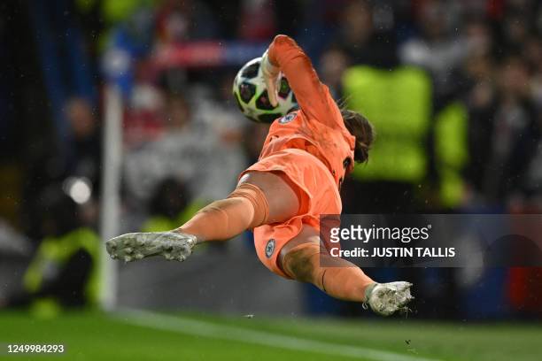Chelsea's German goalkeeper Ann-Katrin Berger saves the vital penalty from Lyon's US midfielder Lindsey Horan in the shoot-out during the UEFA...