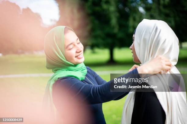 two arabic style women in park - beautiful arabian girls stock-fotos und bilder
