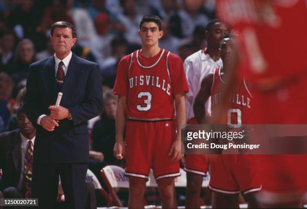 Denny Crum, Head Coach for the University of Louisville Cardinals stands beside Forward Brian Kiser during the NCAA Atlantic Coast Conference college...