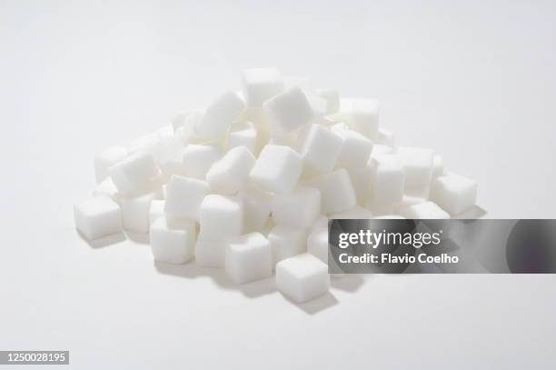 sugar cubes on white surface - sugar pile stock pictures, royalty-free photos & images