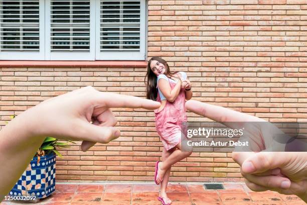 creative child's playing with perspective and optical illusion with giant hands. - cócegas imagens e fotografias de stock