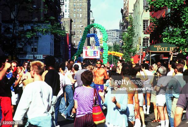 View, looking east, of marchers on Christopher Street during the annual New York City Pride March, New York, New York, June 30, 1985.