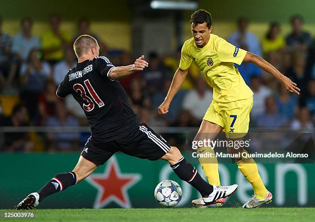 Nilmar of Villarreal is tackled by Bastian Schweinsteiger of Bayern Muenchen during the UEFA Champions League group A match between Villarreal and...